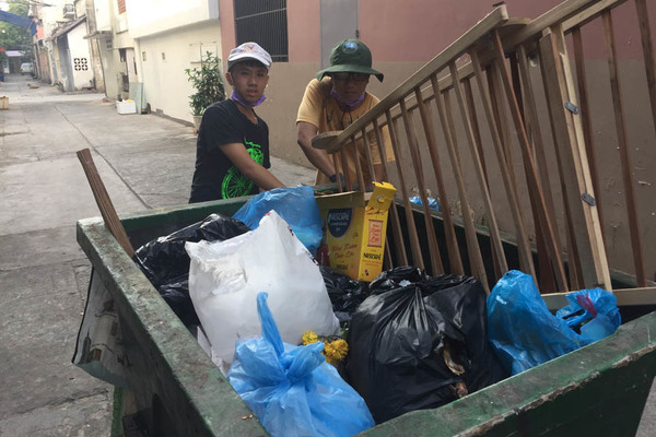 Chị lao công đưa theo 2 con trai dọn rác ngày cuối năm